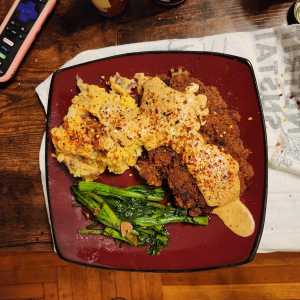 Chicken fried steak with greens, mashed potatoes, and country gravy